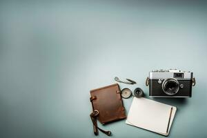 Top view of vintage camera notebook and stationery on grey background AI Generated photo