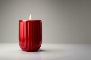 Candle on red container with minimalist background photo