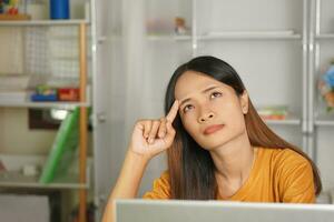 Asian woman working from home Tired of paperwork that is not completed on time photo