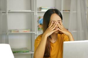 Asian woman working from home Tired of paperwork that is not completed on time photo