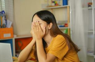 Asian woman working from home Tired of paperwork that is not completed on time photo