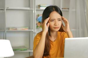 Asian woman working from home Tired of paperwork that is not completed on time photo