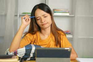 Asian woman working from home Tired of paperwork that is not completed on time photo