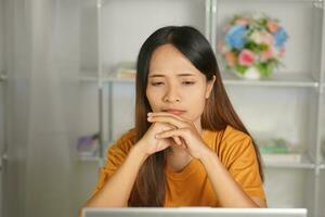 Asian woman working from home Tired of paperwork that is not completed on time photo