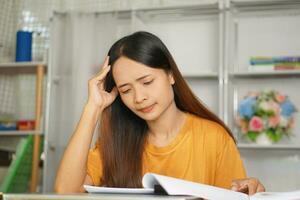 Asian woman working from home Tired of paperwork that is not completed on time photo