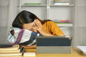 Asian woman sleeping on her desk at home photo
