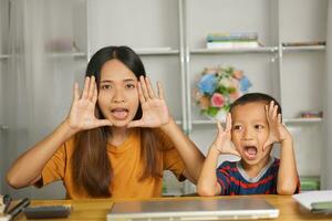 happy mother and son at home desk photo