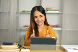 Asian woman at home happy from talking with friends photo