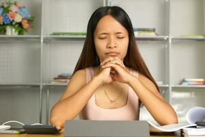 Asian woman working from home Tired of paperwork that is not completed on time photo