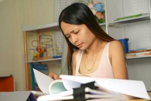 Asian woman working from home Tired of paperwork that is not completed on time photo