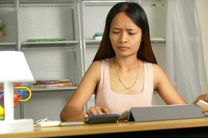 Asian woman working from home Tired of paperwork that is not completed on time photo