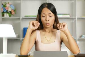 woman working at home Shocked by high profitable trading results photo