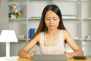 woman working at home Use the computer to communicate with the work team. photo