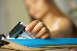 woman working at home Pick up documents from the desk. photo