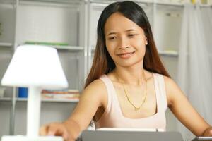 woman working at home Turn off the lights after work photo