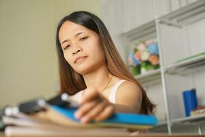 woman working at home Pick up documents from the desk. photo