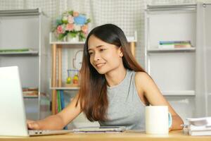 business woman working from home Use a computer to contact the team. photo