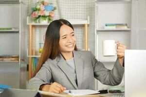 business woman working from home Drink tea to refresh your body. photo