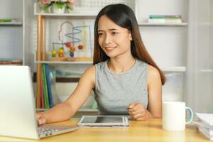 business woman working from home Use a computer to contact the team. photo