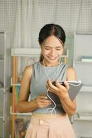 female college students use computers to listen to music photo