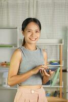 Woman pressing a calculator in the room photo