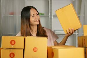 Online sellers check product boxes before delivering to customers. photo