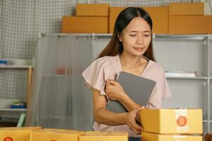 Online sellers check the customer's address on the box before sending the goods. photo