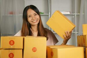 Online sellers check product boxes before delivering to customers. photo