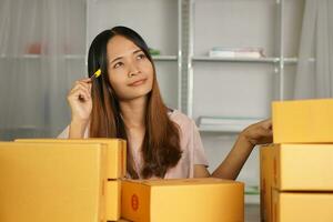 Online retailer checking customer's address on box before sending the goods photo