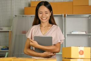 Online sellers check the customer's address on the box before sending the goods. photo