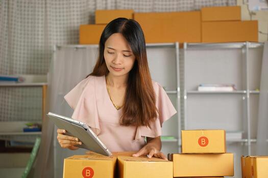 Online merchants view purchase orders via computer. to deliver products to customers photo