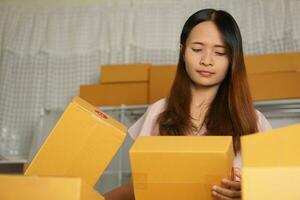 Online sellers check product boxes before delivering to customers. photo