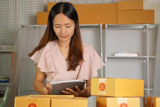 Online merchants view purchase orders via computer. to deliver products to customers photo