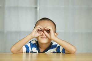 Boy making glasses with his hands photo