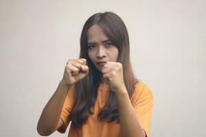 A woman raises her fist with confidence. photo