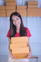 Online seller carries boxes of products Prepare to send to customers photo