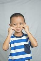 Happy smiling boy taking photo in studio