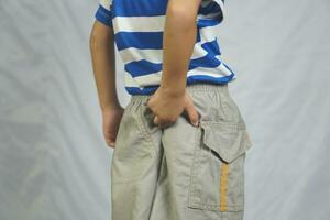 A boy has itching on his buttocks. photo