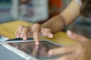 asiático mujer trabajando a hogar utilizar tu mano a toque el computadora pantalla. foto