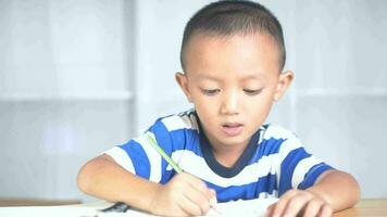 Boy practicing writing numbers and letters at home video