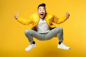 A picture of a happy young asian man jumping in the air in front of a yellow background, ai generative photo