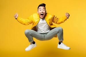 A picture of a happy young asian man jumping in the air in front of a yellow background, ai generative photo