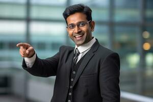 Photo of a happy indian businessman pointing at something looking like he is advertising or recommending a new commercial promotion, ai generative