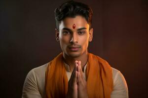 A photo of a handsome young indian man with his hands folded in prayer facing the camera, ai generative