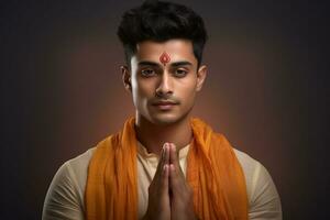 A photo of a handsome young indian man with his hands folded in prayer facing the camera, ai generative