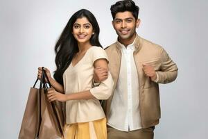 A picture of a young indian couple carrying shopping bags with a white background, ai generative photo