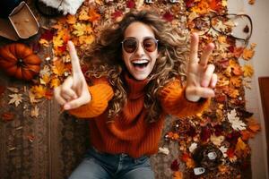 A picture of a young woman sitting on the carpet at home surrounded by autumn decorations making a victory sign with her fingers, ai generative photo