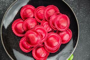 beet ravioli red color meat filling smoked ham Cooking appetizer meal food snack on the table photo