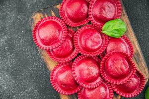 beet ravioli red color meat filling smoked ham Cooking appetizer meal food snack on the table photo