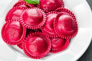 beet ravioli red color meat filling smoked ham Cooking appetizer meal food snack on the table photo